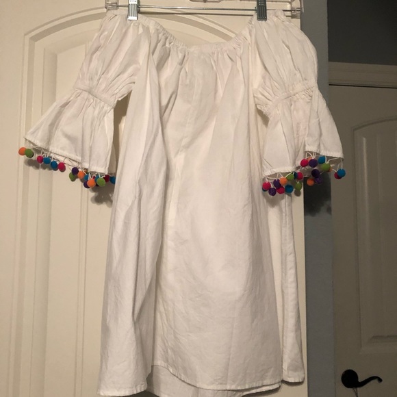 white dress with colorful pom poms